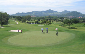 Player putting on green, burapha golf club, pattaya, thailand